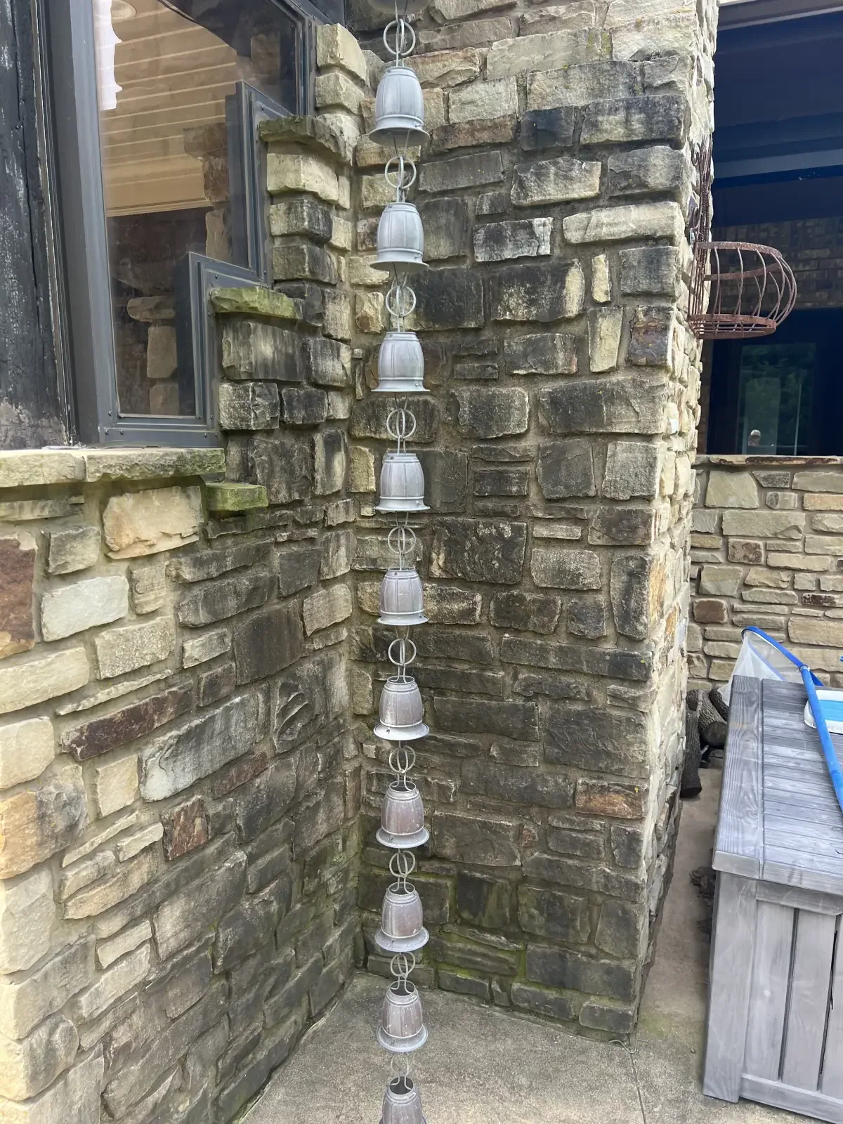 Stone exterior and rain chain before soft washing